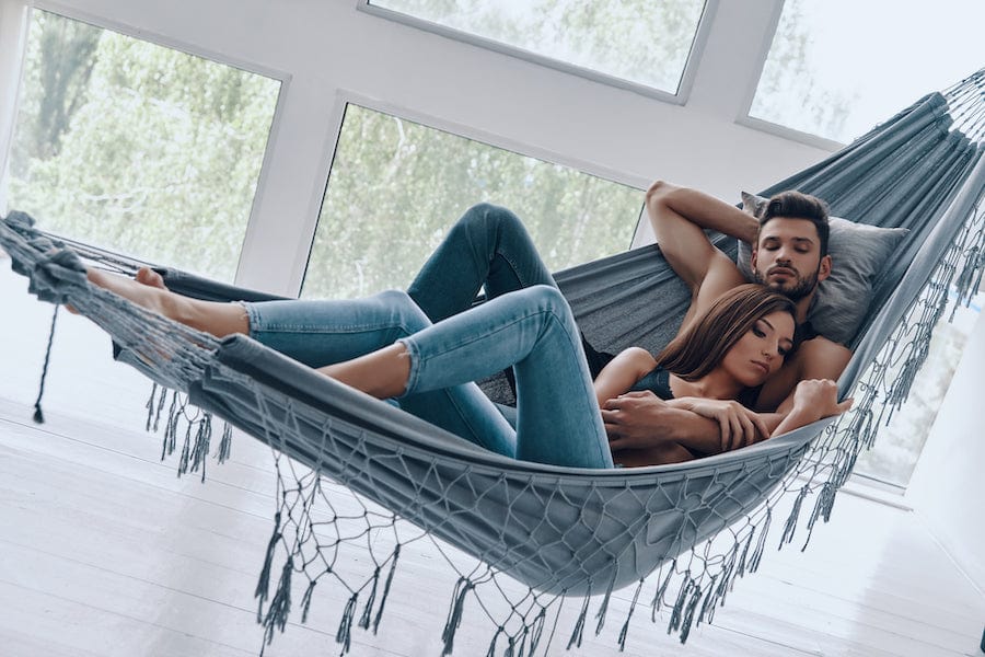 Cozy Brazilian hammock set up indoors with pillows and blanket, perfect for winter relaxation