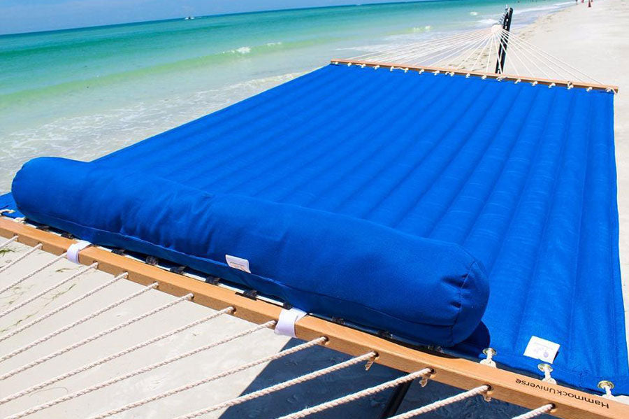 A blue poolside Hammock Universe hammock on a sunny beach.