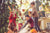 A family playing in fallen leaves in autumn.