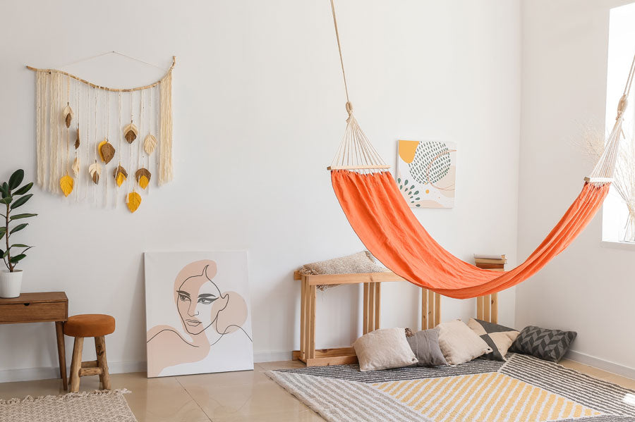 A hammock hung up in a modern home living room.