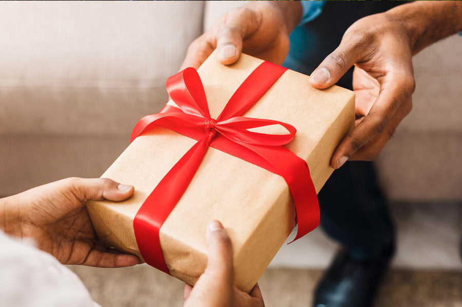 A person handing a gift to someone.