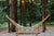 A string hammock on a hammock stand made of Bamboo/Wood in the woods