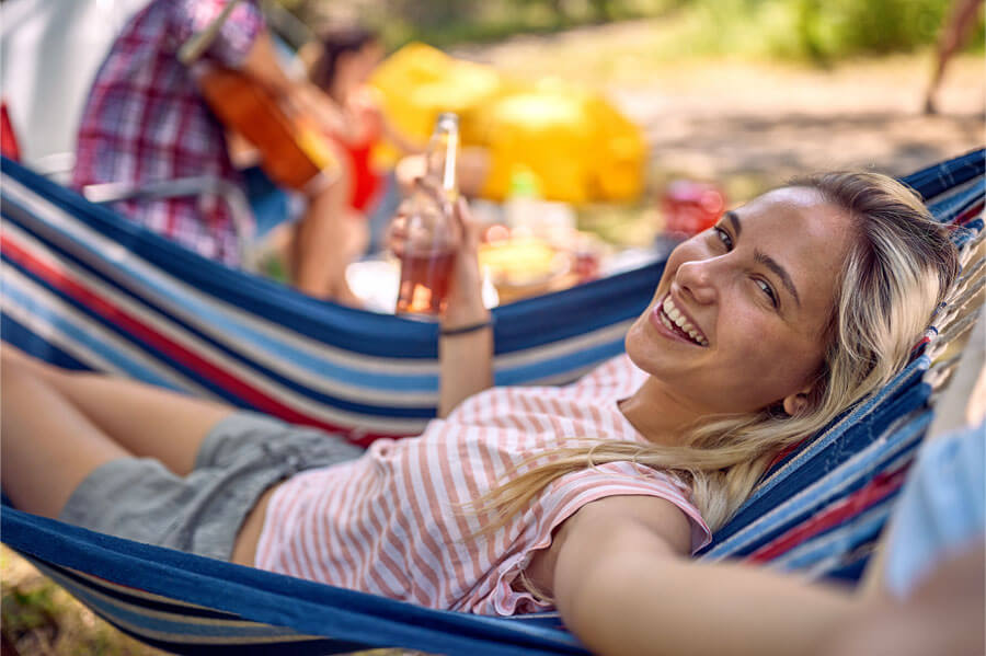 Women celebrating National Hammock Day with a hammock in the great outdoors