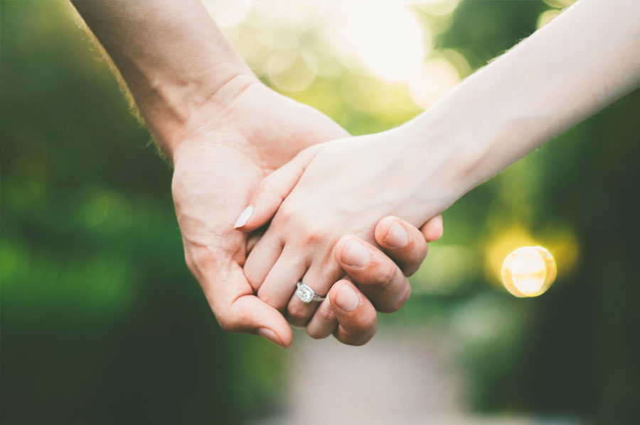 A couple holding hands.