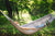 Women relaxing in her hammock outdoors enjoying the fresh air and embracing a tech-healthy lifestyle