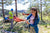 Men and Women Outdoors installing their hammock to two trees after consulting the Hammock Hangin calculator