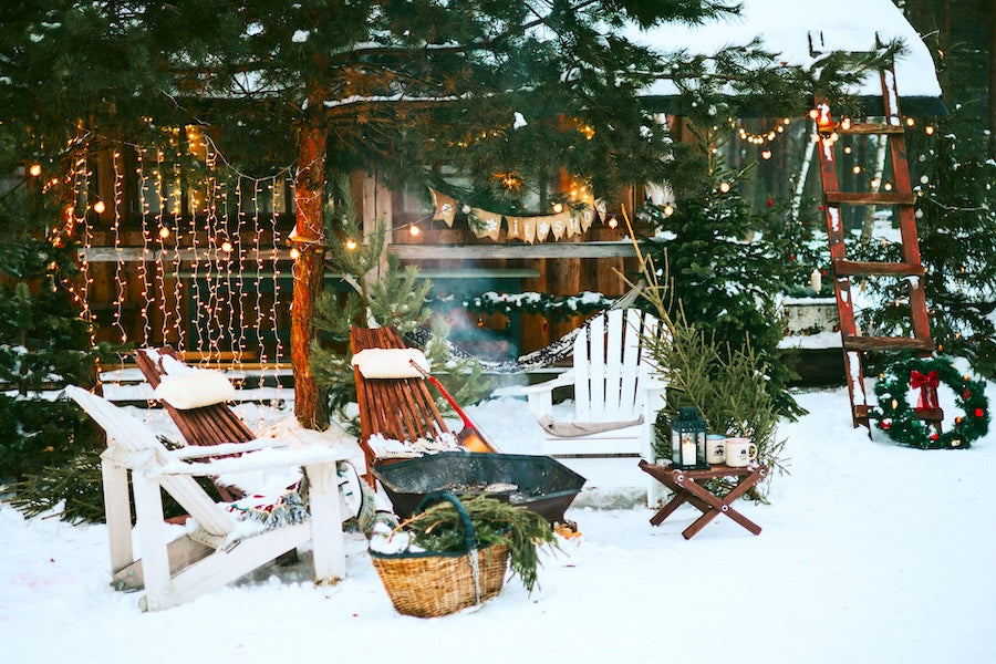 backyard in winter, lights, chairs and evergreens