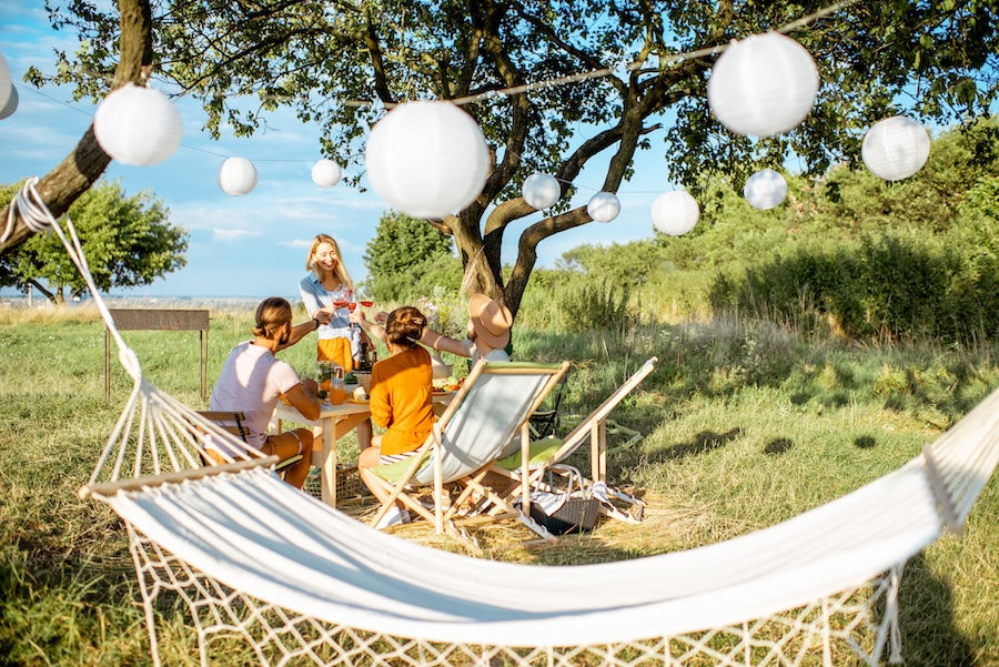 outdoor setting, family picnic, hammock in focus. 