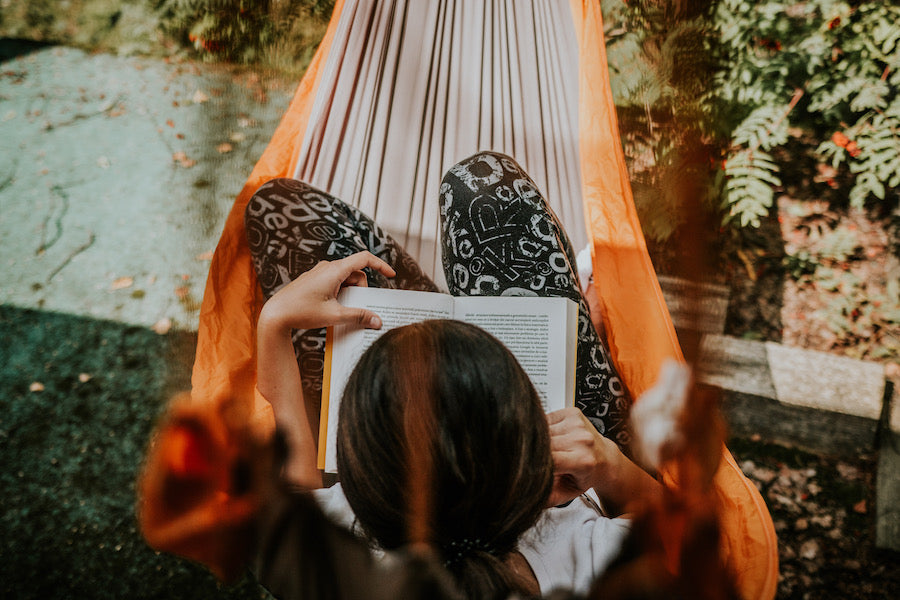 A overhead view of a woman reading in her hammock.