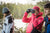 A father and two grown kids birdwatching in nature in cold weather