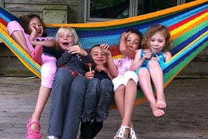 children enjoying themselves in a colourful mayan hammock