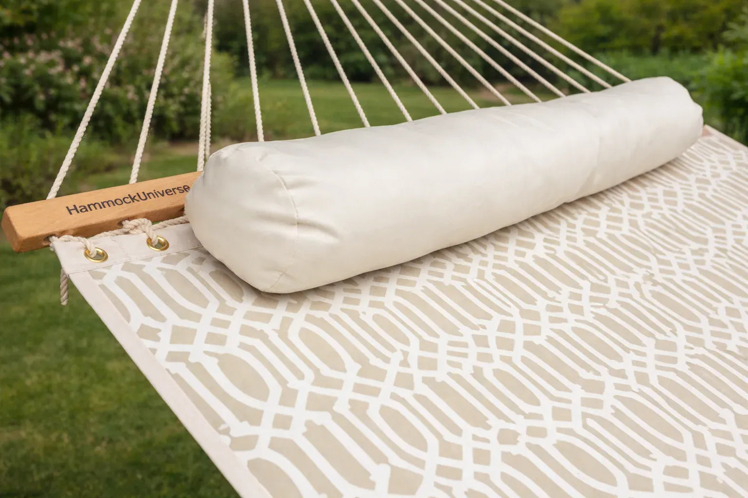 Rolled-up hammock with 'Hammock Universe' branding on a hammock in an outdoor setting.  QHD-COUNTRY