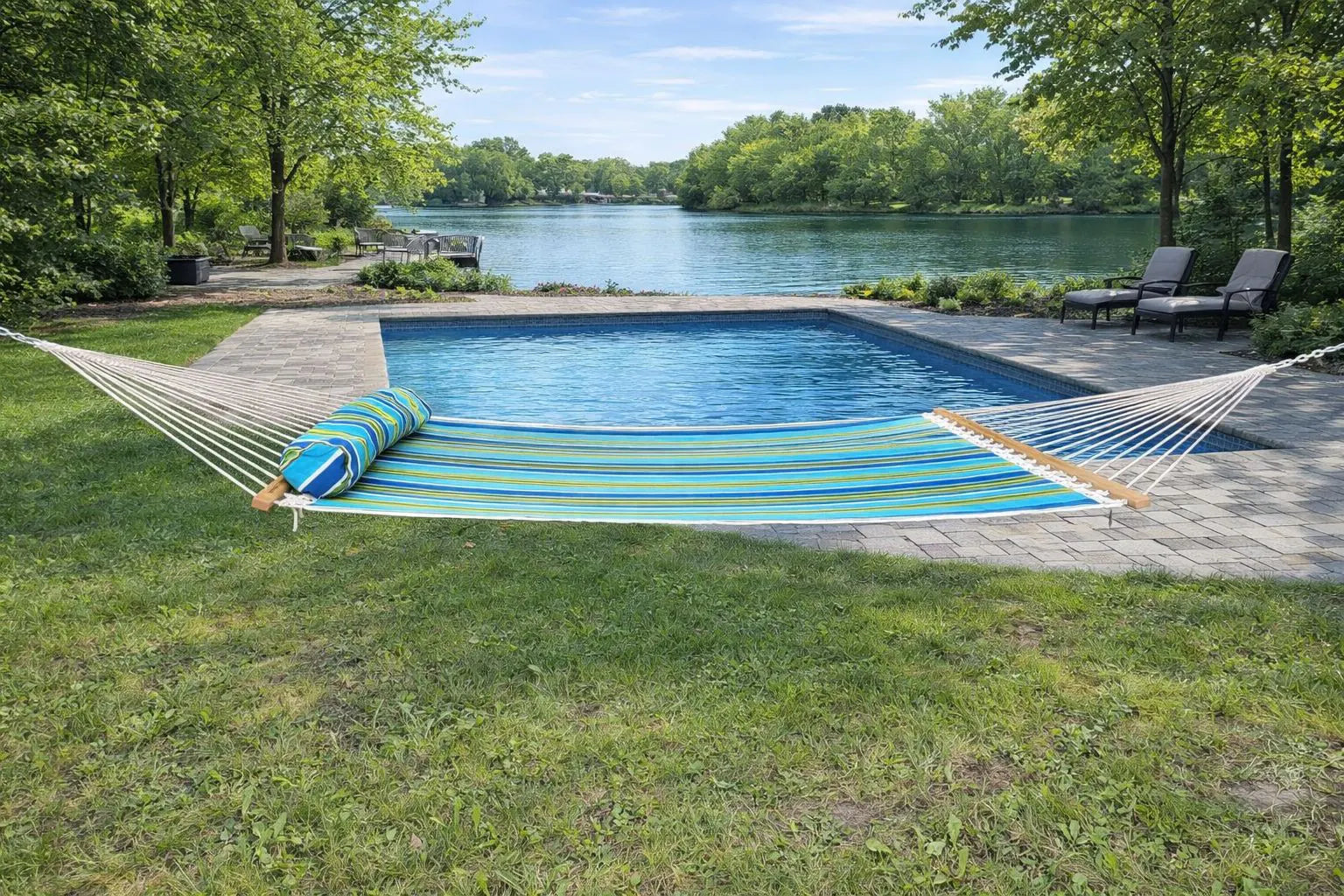 Blue striped hammock by a pool with a scenic background   QHD-CAROLINA